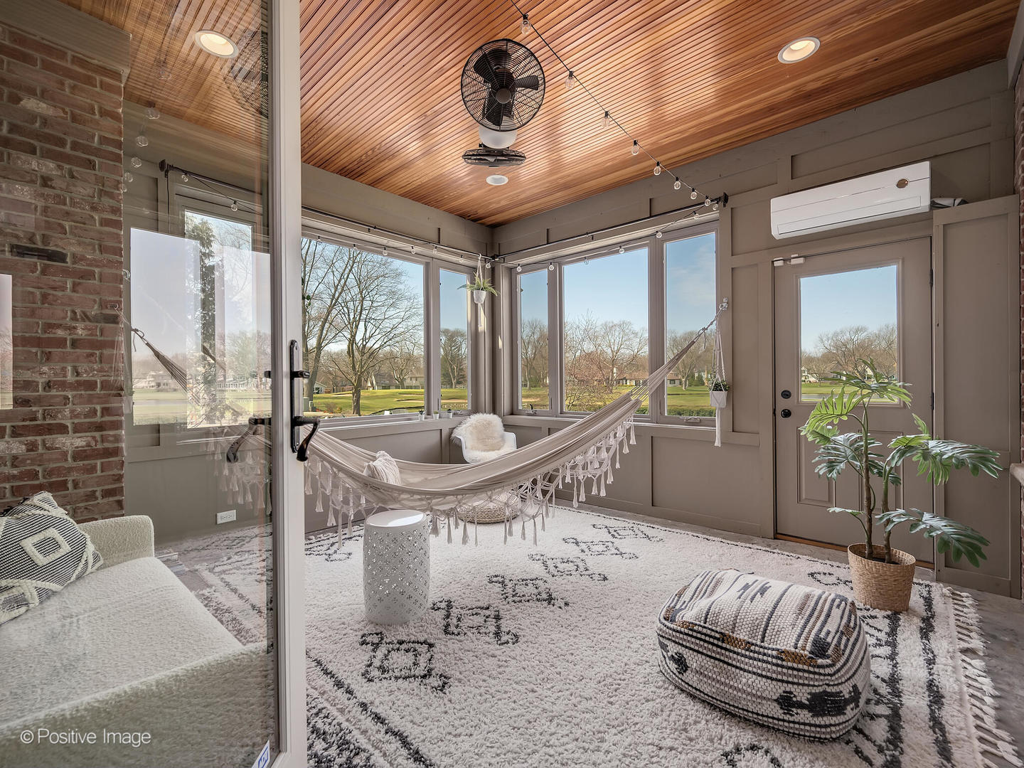 1129 Summit Hills Lane Naperville, IL 60563 - Photo 28 of 72 a living room with furniture and a floor to ceiling window