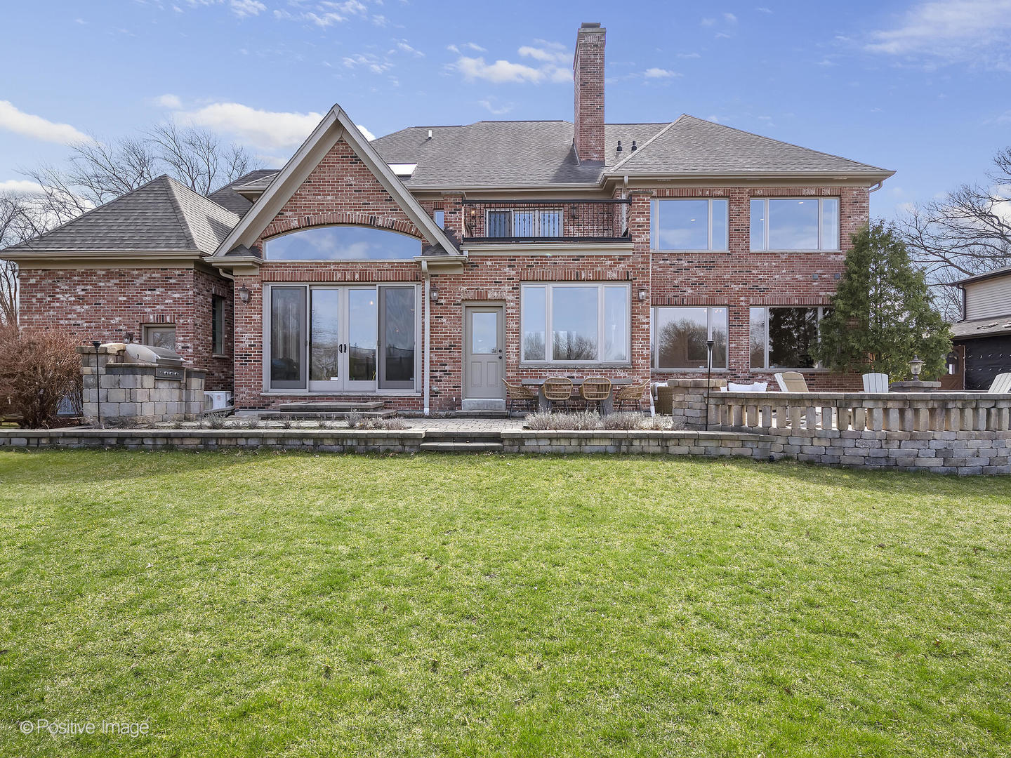 1129 Summit Hills Lane Naperville, IL 60563 - Photo 59 of 72 a front view of a house with swimming pool lawn chairs and a fireplace