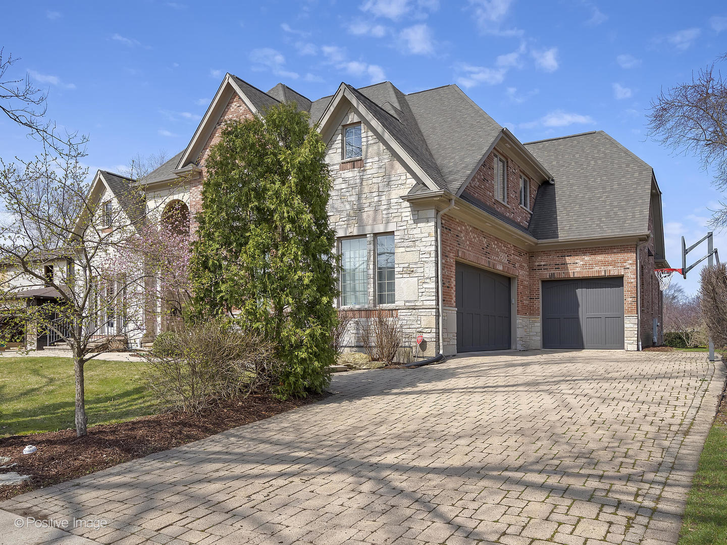 1129 Summit Hills Lane Naperville, IL 60563 - Photo 61 of 72 a view of a white house with a yard and potted plants
