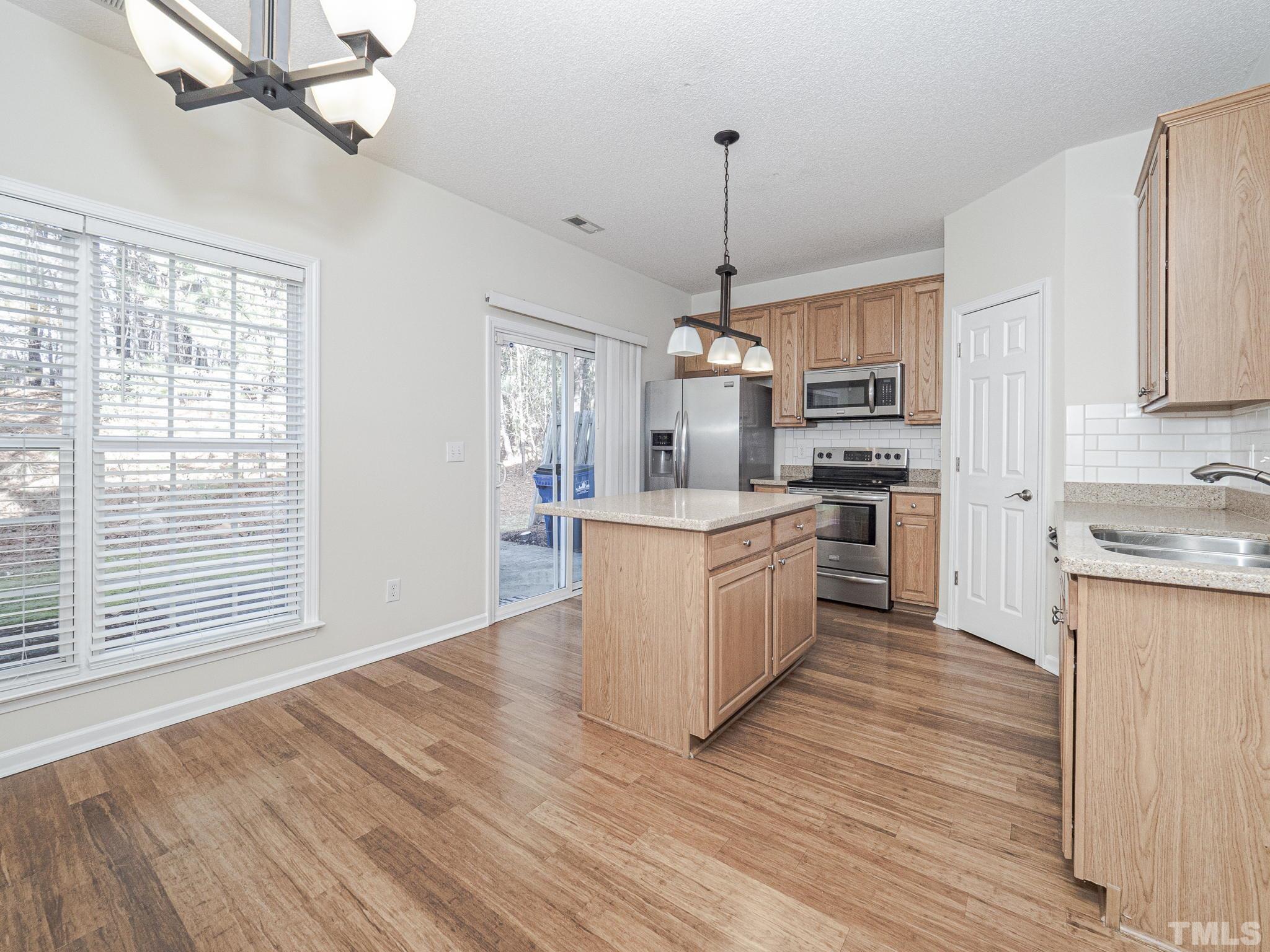 2925 Winding Waters Way Raleigh, NC 27614 - Photo 11 of 21 Sliding glass doors leading to the concrete patio are perfect for indoor/outdoor entertaining.