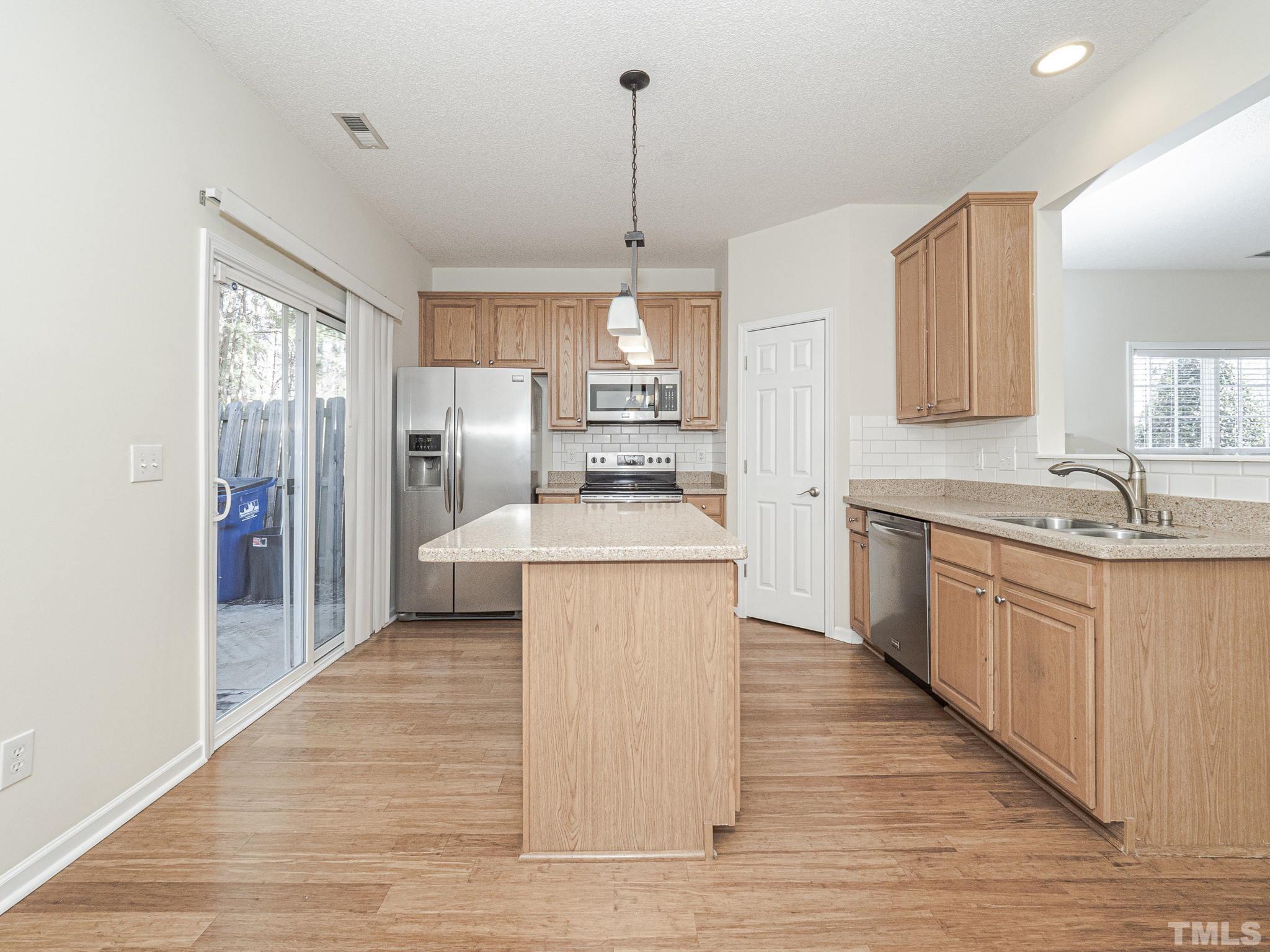 2925 Winding Waters Way Raleigh, NC 27614 - Photo 12 of 21 The pass-through from the family room to the kitchen allows for effortless entertaining.
