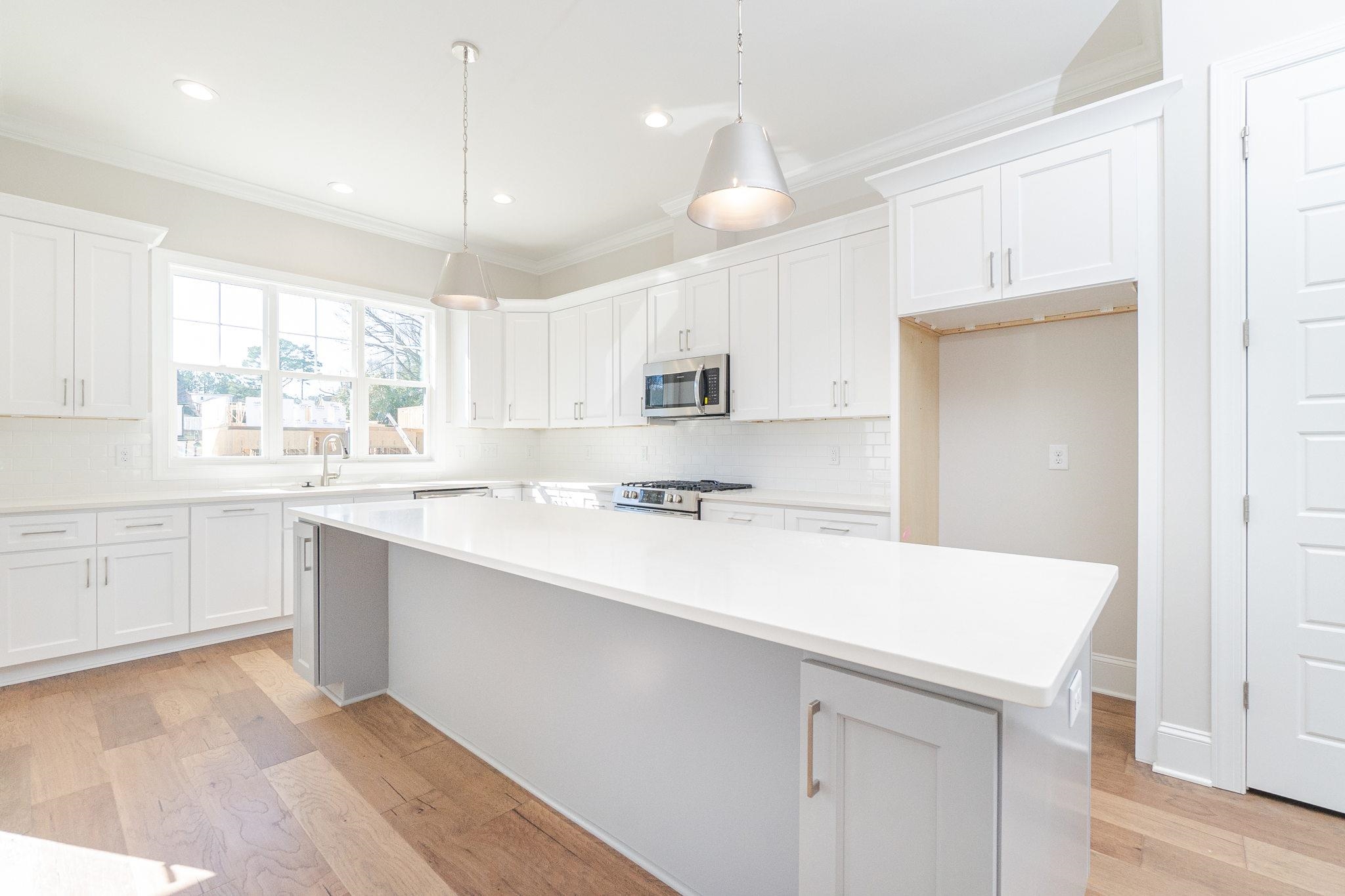 4916 Trek Lane Raleigh, NC 27606 - Photo 12 of 28 a kitchen with kitchen island a sink appliances and cabinets
