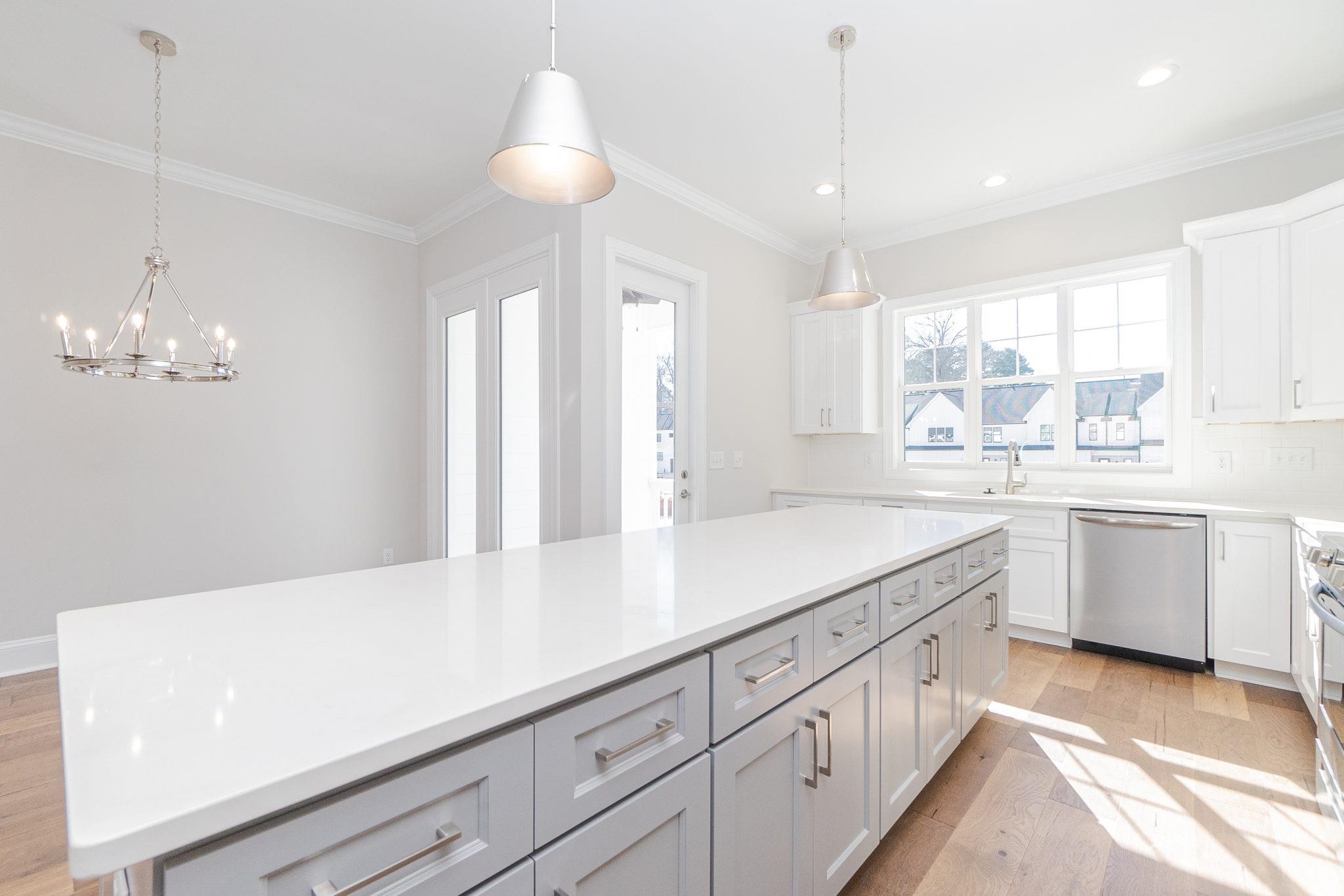 4916 Trek Lane Raleigh, NC 27606 - Photo 14 of 28 a kitchen with cabinets a sink dishwasher a stove and a refrigerator with wooden floor