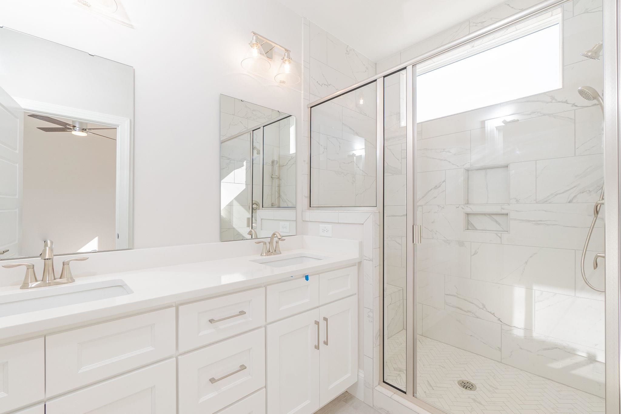 4916 Trek Lane Raleigh, NC 27606 - Photo 21 of 28 a bathroom with a shower sink and mirror