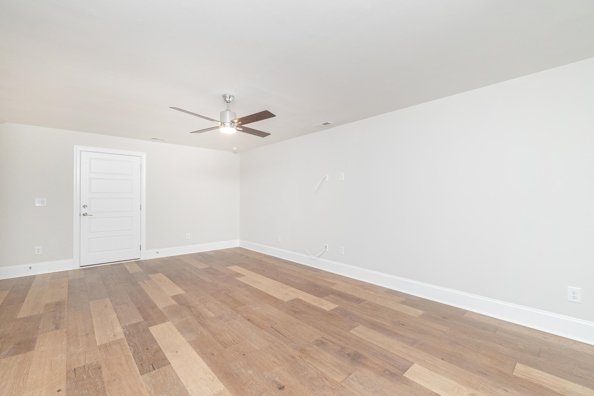 4916 Trek Lane Raleigh, NC 27606 - Photo 22 of 28 a view of a room with wooden floor and a ceiling fan