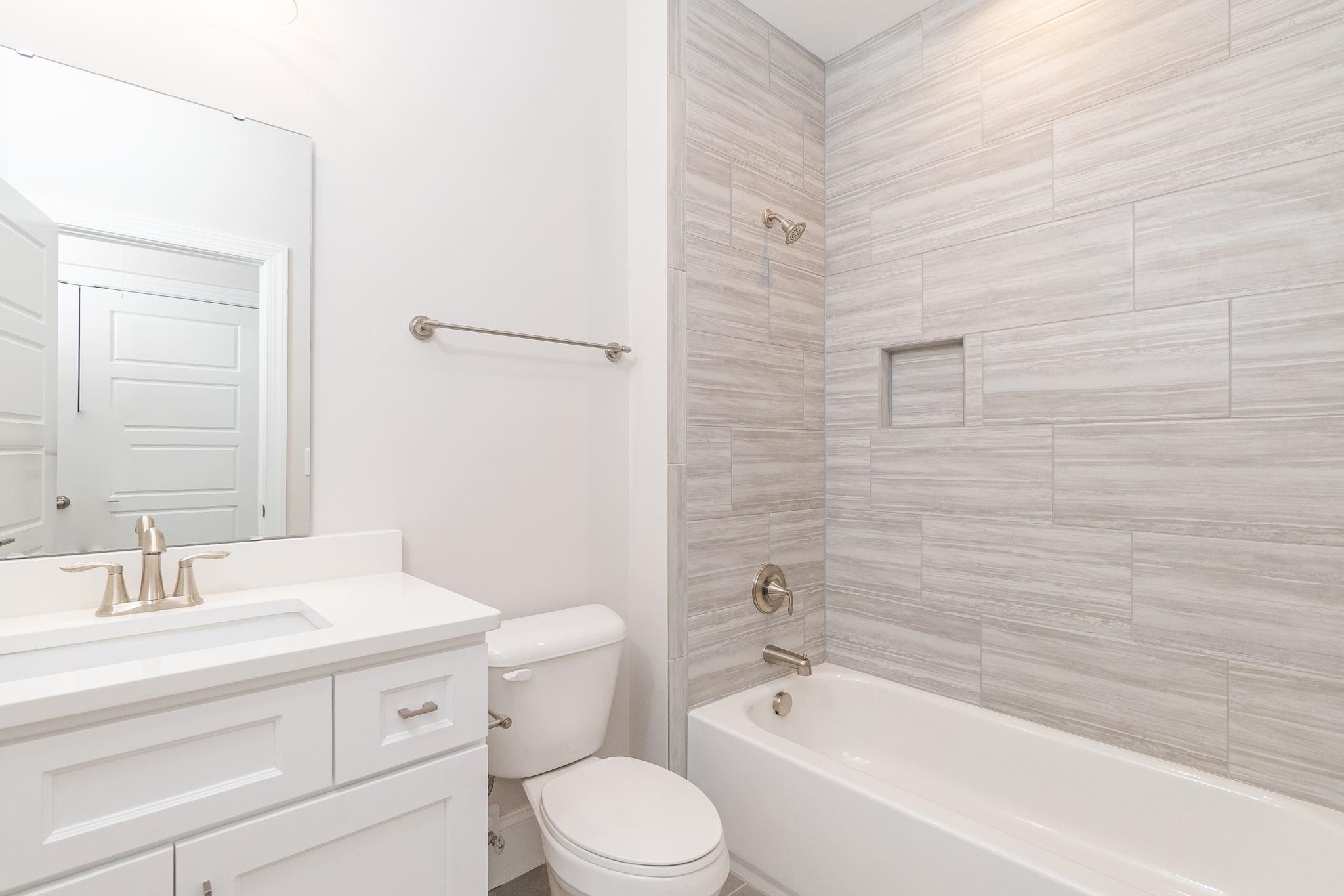 4916 Trek Lane Raleigh, NC 27606 - Photo 25 of 28 a bathroom with a granite countertop toilet a sink and bathtub