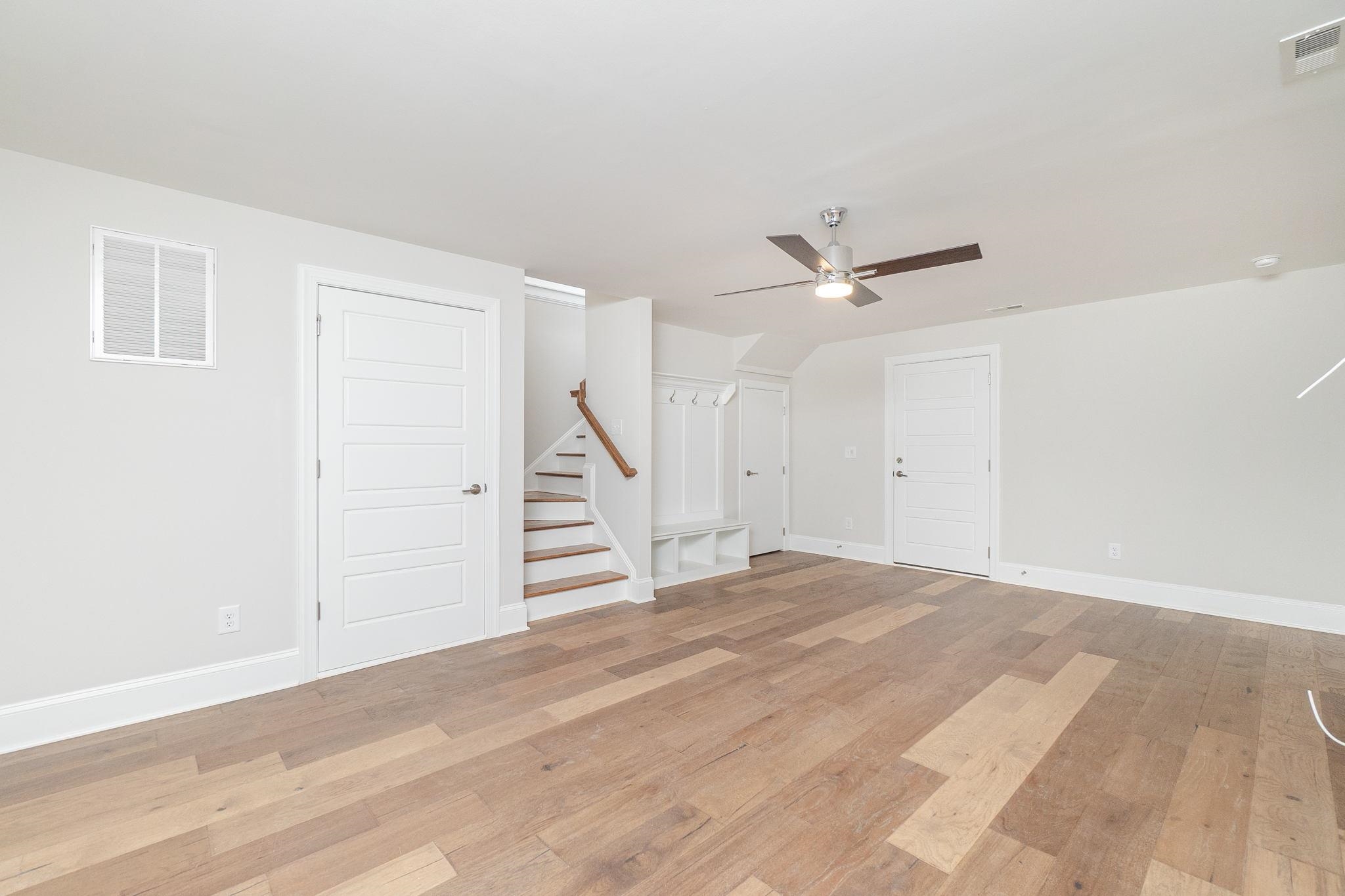 4916 Trek Lane Raleigh, NC 27606 - Photo 27 of 28 a view of an empty room with wooden floor and a ceiling fan