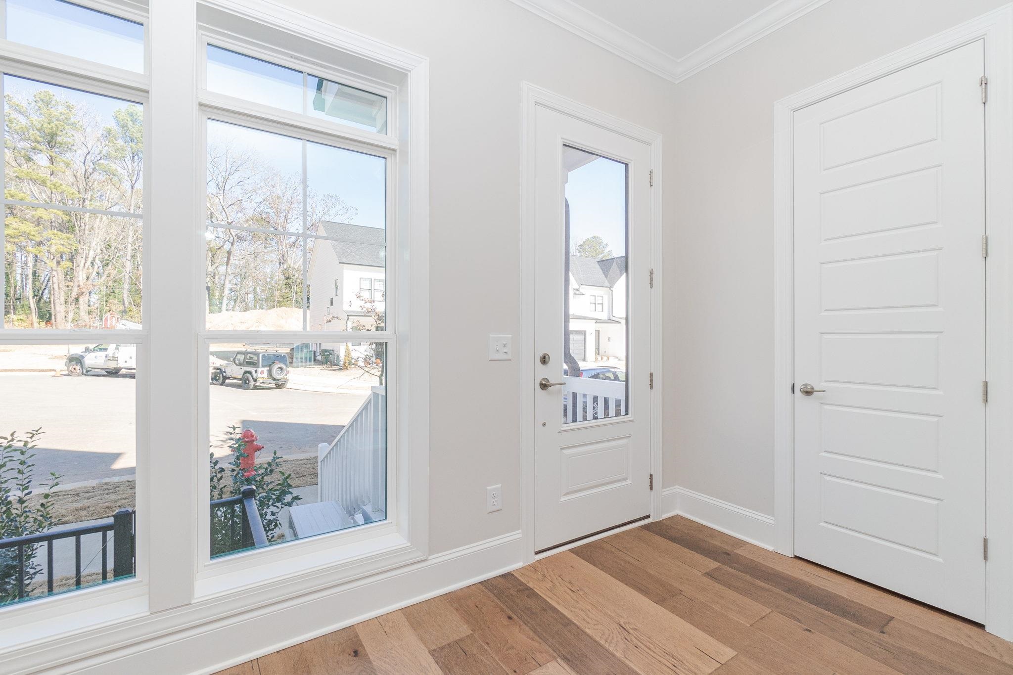 4916 Trek Lane Raleigh, NC 27606 - Photo 4 of 28 an empty room with wooden floor and windows
