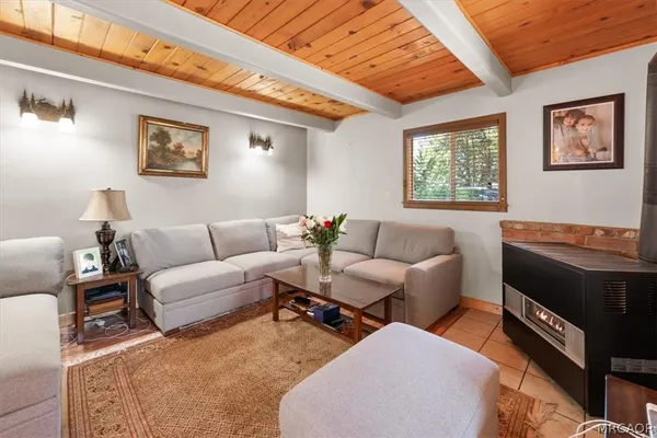 a living room with furniture a rug and a window