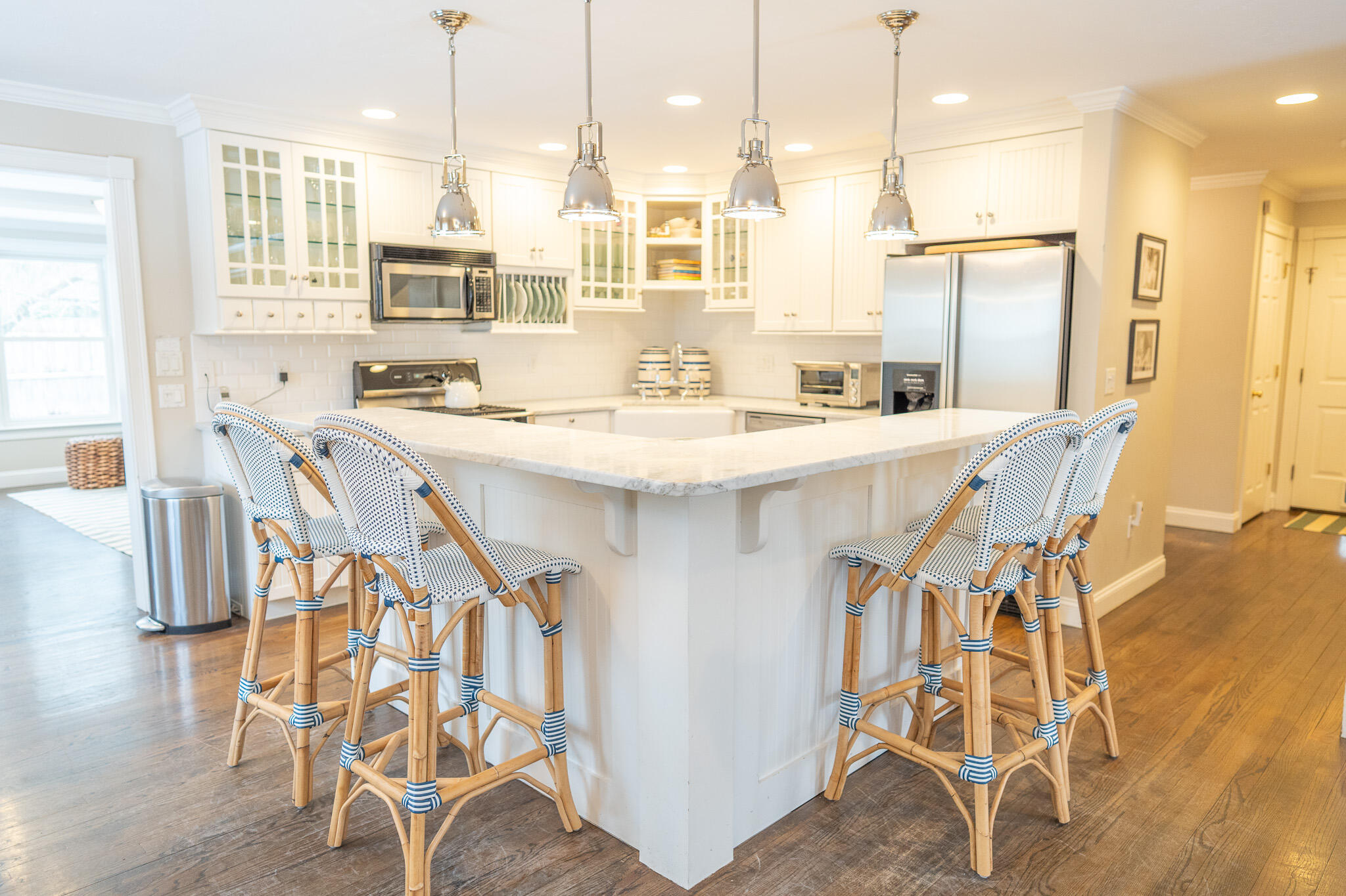 10 Abbey Gate Road Cotuit, MA 02635 - Photo 19 of 67 a kitchen with stainless steel appliances kitchen island granite countertop a table chairs stove and white cabinets