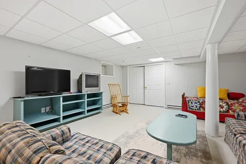 a bedroom with furniture and a flat screen tv