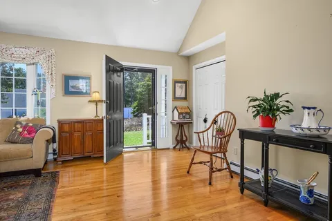 a living room with furniture and a potted plant