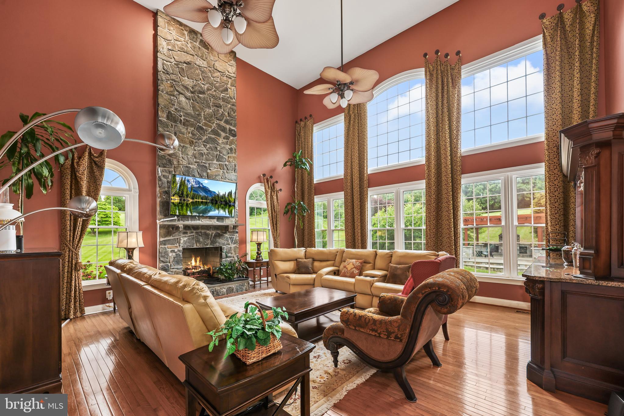 40890 Beechnut Road Leesburg, VA 20175 - Photo 23 of 65 a living room with furniture fireplace and floor to ceiling windows