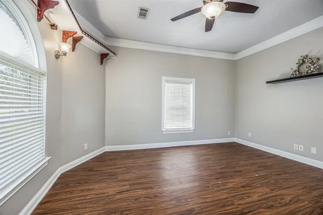 a view of a room with wooden floor and windows