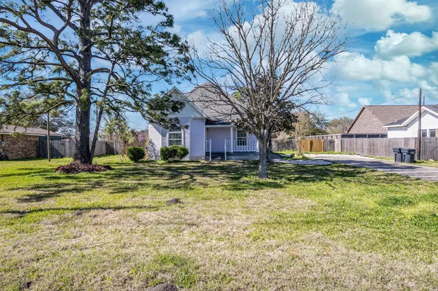 a front view of house with yard and trees around