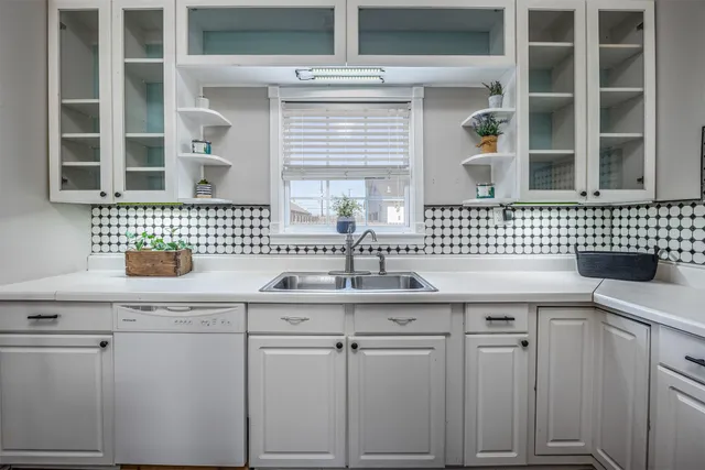 a kitchen with a sink and cabinets