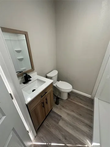 a bathroom with a toilet a sink and mirror