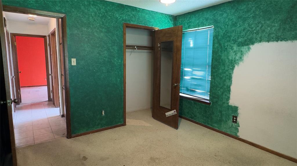 415 Meadowlark Trail Springtown, TX 76082 - Photo 16 of 35 an empty room with windows next to a yard