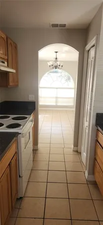 a kitchen with a sink a stove and a refrigerator