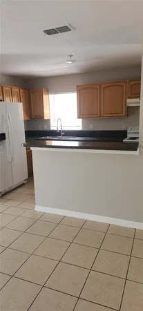 a view of a kitchen with an empty space and a window