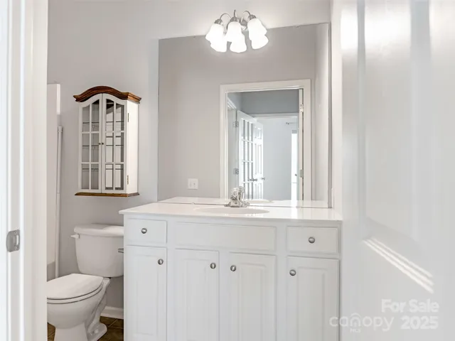 a bathroom with a sink a toilet and a mirror