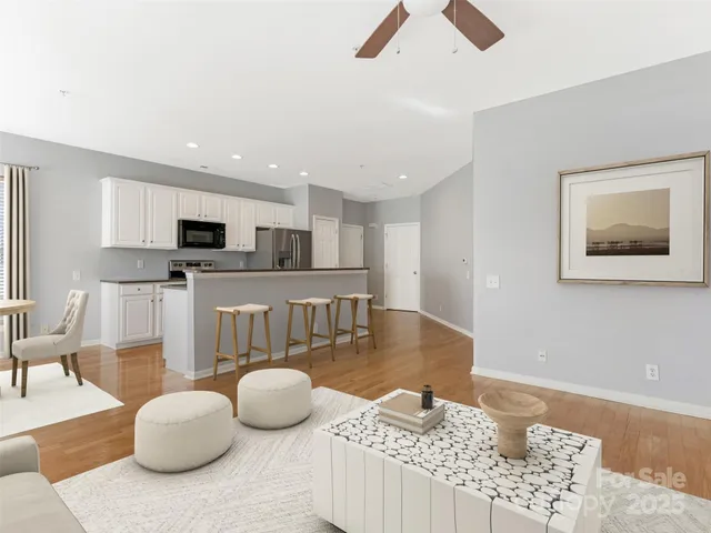 a living room with furniture and kitchen view
