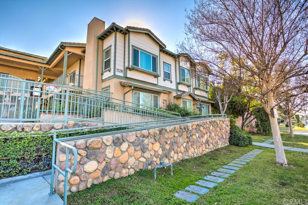 1128 West Duarte Road, Unit N Arcadia, CA 91007 - Photo 1 of 1 a front view of a house with a yard table and chairs