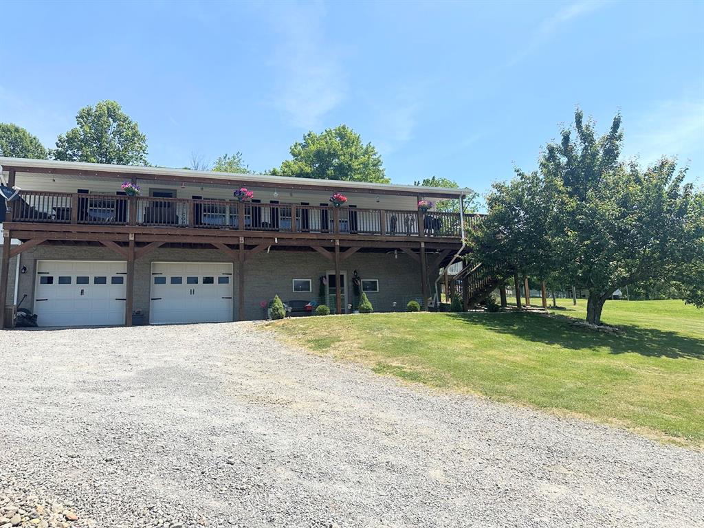 155 Crimm Road Ford City, PA 16226 - Photo 3 of 3 a front view of a house with a garden and tree