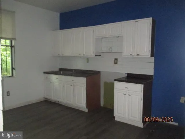 a kitchen with a white cabinets and a stove
