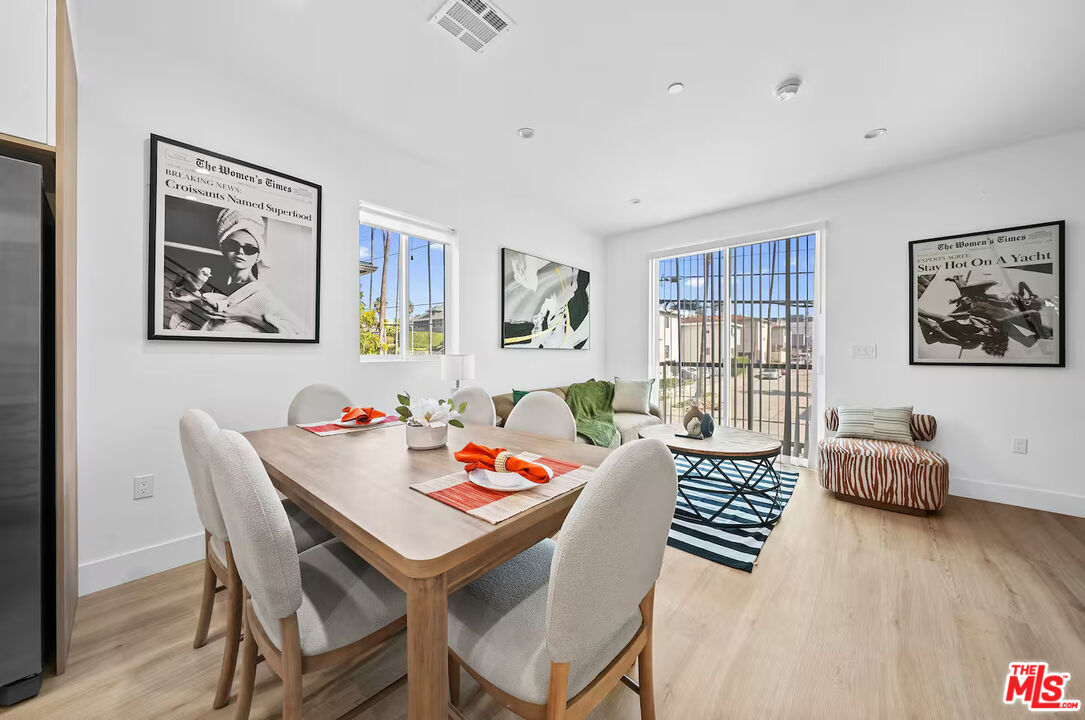 201 South Westlake Avenue, Unit 203 1/2 Los Angeles, CA 90057 - Photo 12 of 27 a dining room with furniture and wooden floor