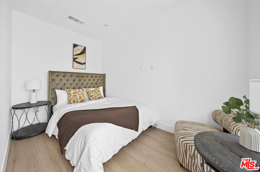 201 South Westlake Avenue, Unit 203 1/2 Los Angeles, CA 90057 - Photo 19 of 27 a bedroom with a bed and couch