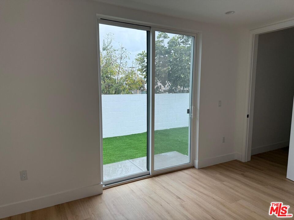 201 South Westlake Avenue, Unit 203 1/2 Los Angeles, CA 90057 - Photo 23 of 27 a view of an empty room with wooden floor and a window