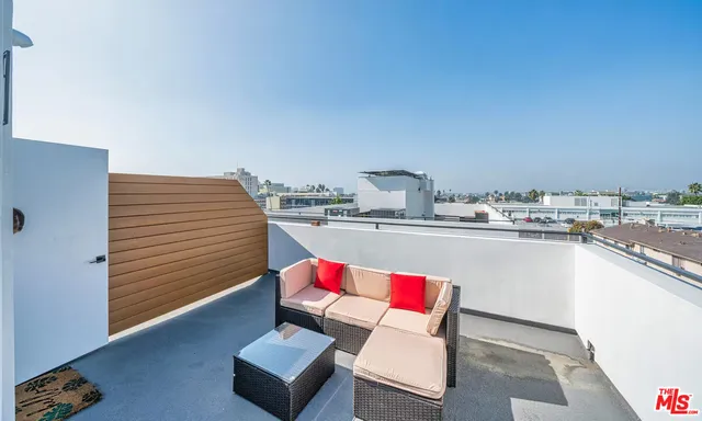 a living room with kitchen island furniture and a wooden floor