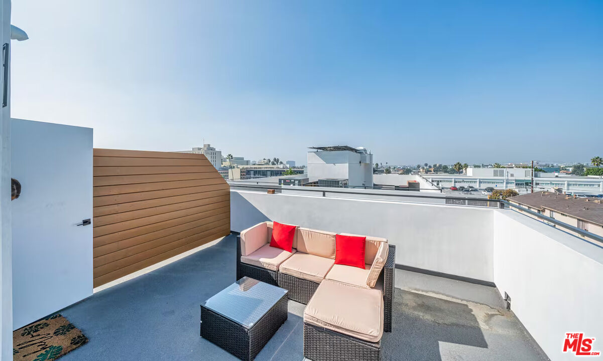 201 South Westlake Avenue, Unit 203 1/2 Los Angeles, CA 90057 - Photo 7 of 27 a living room with kitchen island furniture and a wooden floor