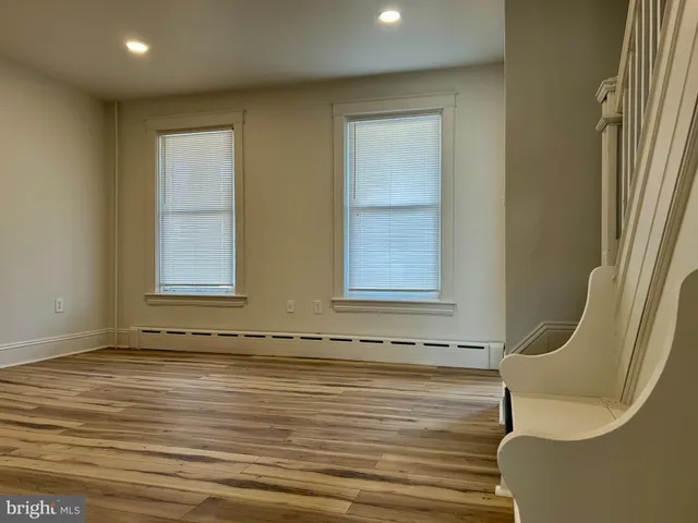 a view of wooden floor and windows