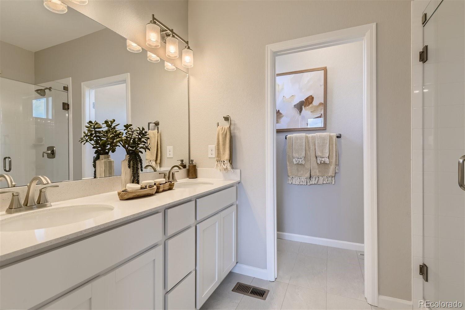 450 Millwall Circle Castle Pines, CO 80108 - Photo 15 of 23 a bathroom with a sink and a mirror