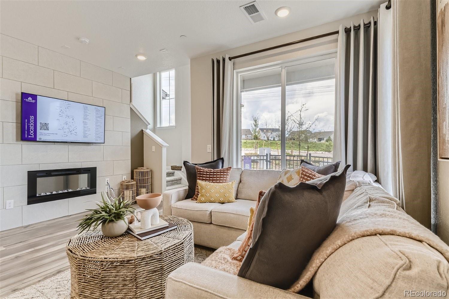 450 Millwall Circle Castle Pines, CO 80108 - Photo 6 of 23 a living room with furniture and a fireplace