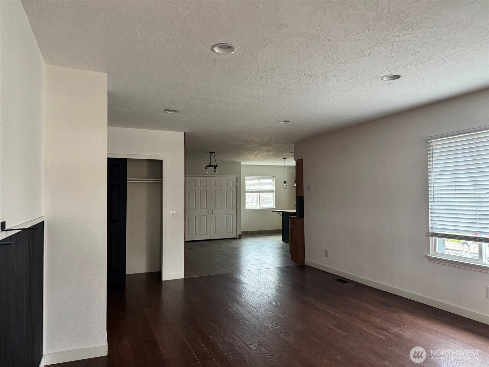 21 Orchard Loop North Tonasket, WA 98855 - Photo 11 of 23 an empty room with wooden floor and windows