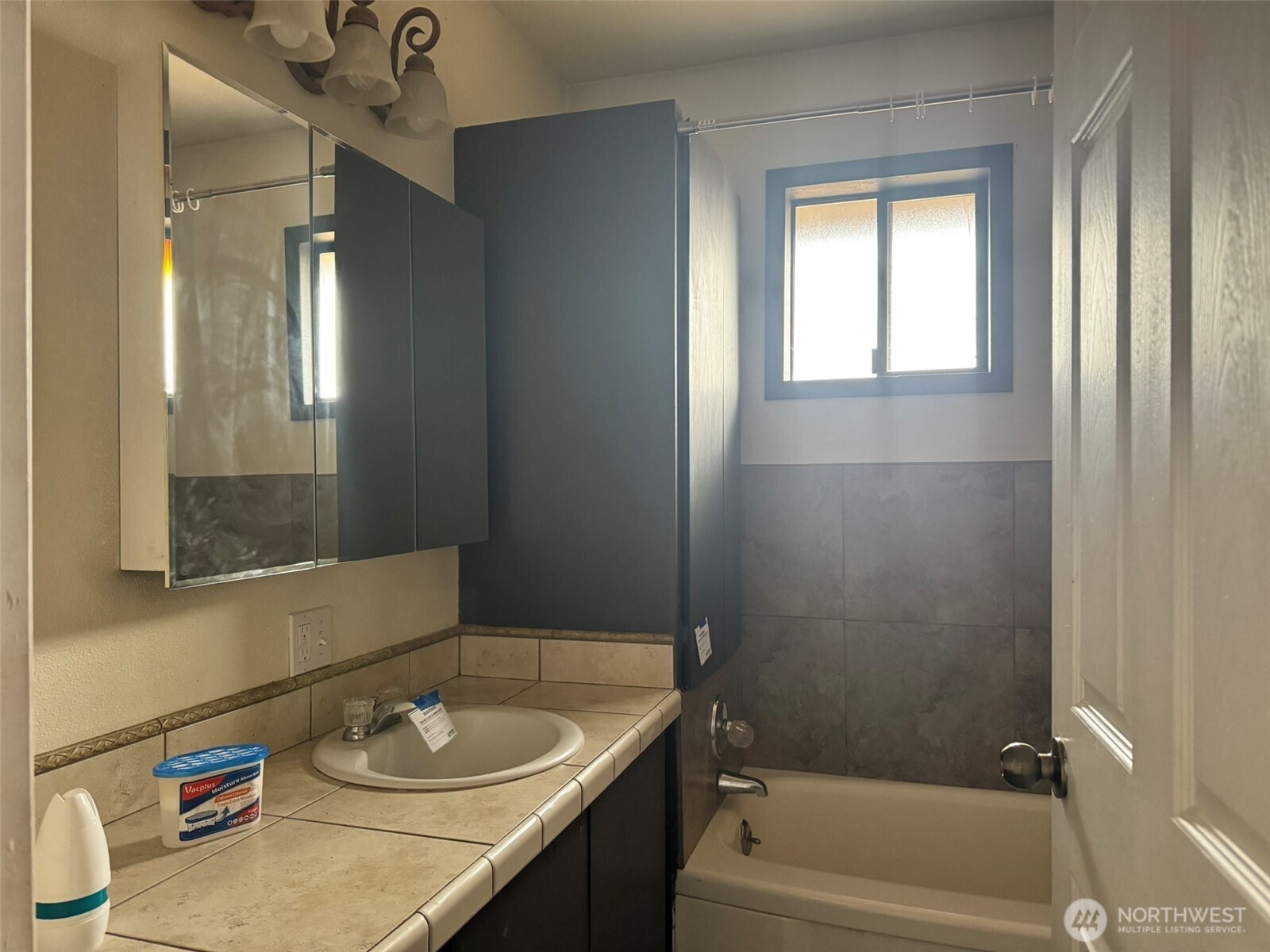 21 Orchard Loop North Tonasket, WA 98855 - Photo 15 of 23 a bathroom with a granite countertop sink toilet and a bathtub