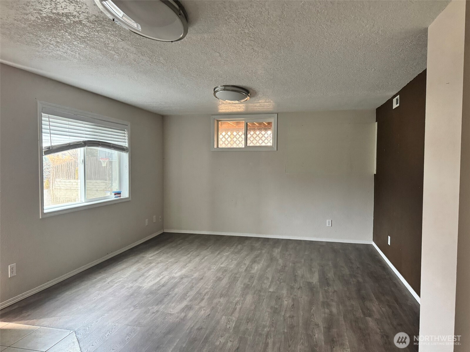 21 Orchard Loop North Tonasket, WA 98855 - Photo 16 of 23 a view of an empty room with wooden floor and a window