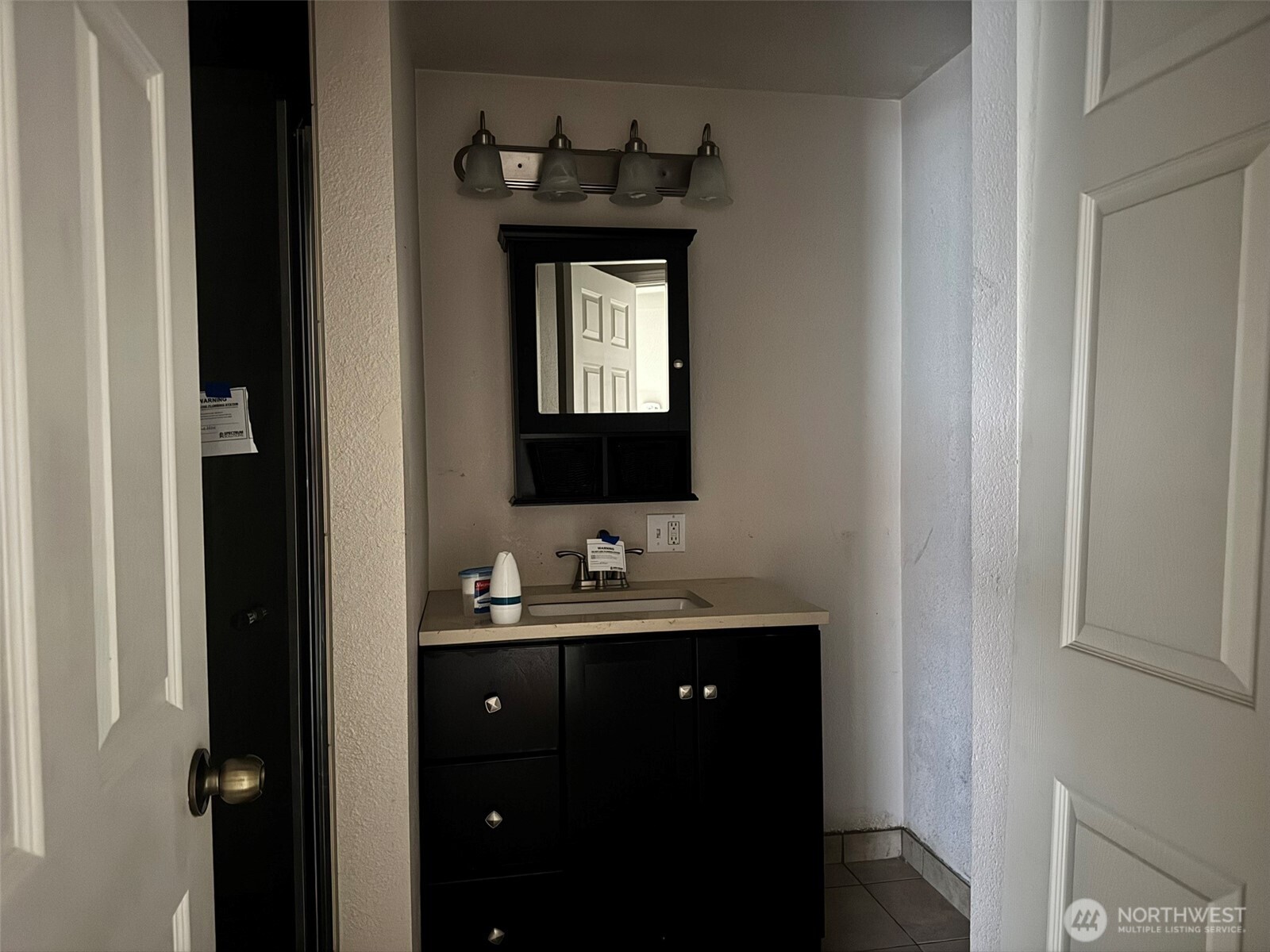 21 Orchard Loop North Tonasket, WA 98855 - Photo 18 of 23 a bathroom with a sink and a mirror