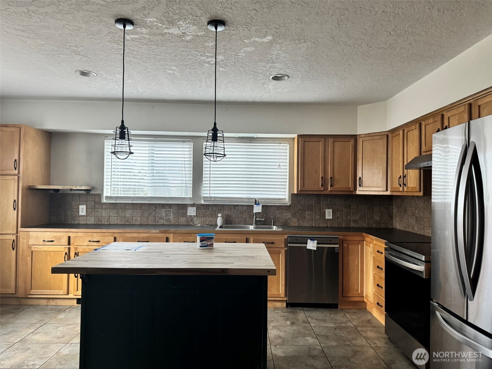 21 Orchard Loop North Tonasket, WA 98855 - Photo 4 of 23 a kitchen with kitchen island a sink appliances and cabinets