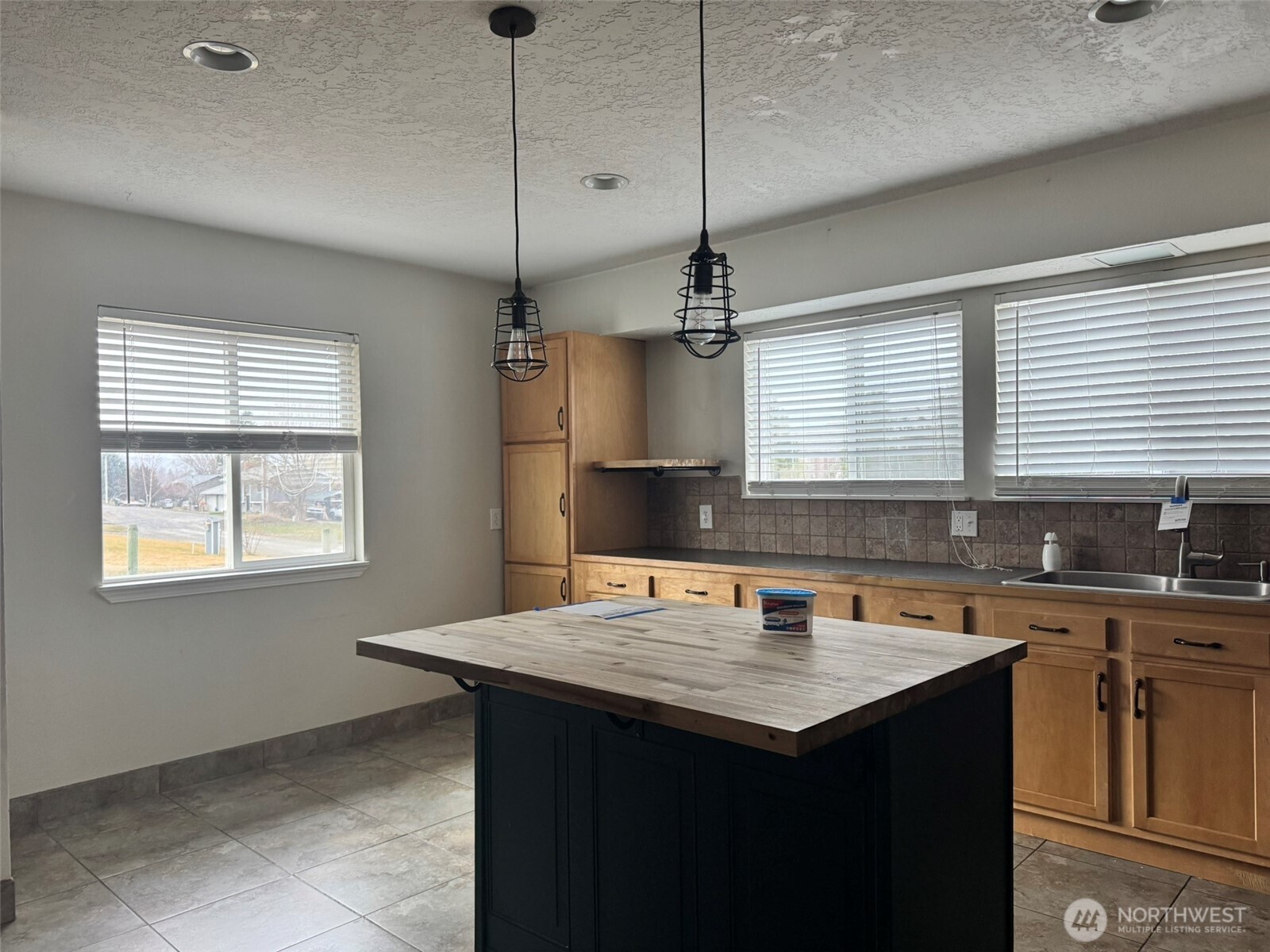 21 Orchard Loop North Tonasket, WA 98855 - Photo 5 of 23 a kitchen with a counter space a sink cabinets and appliances