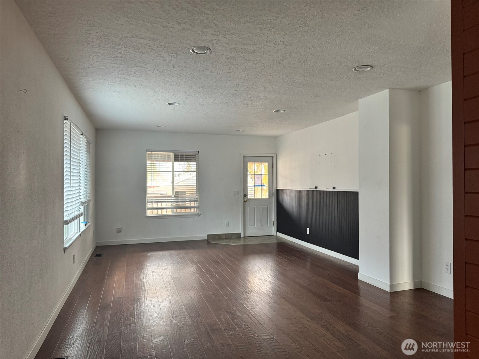21 Orchard Loop North Tonasket, WA 98855 - Photo 9 of 23 an empty room with wooden floor and windows