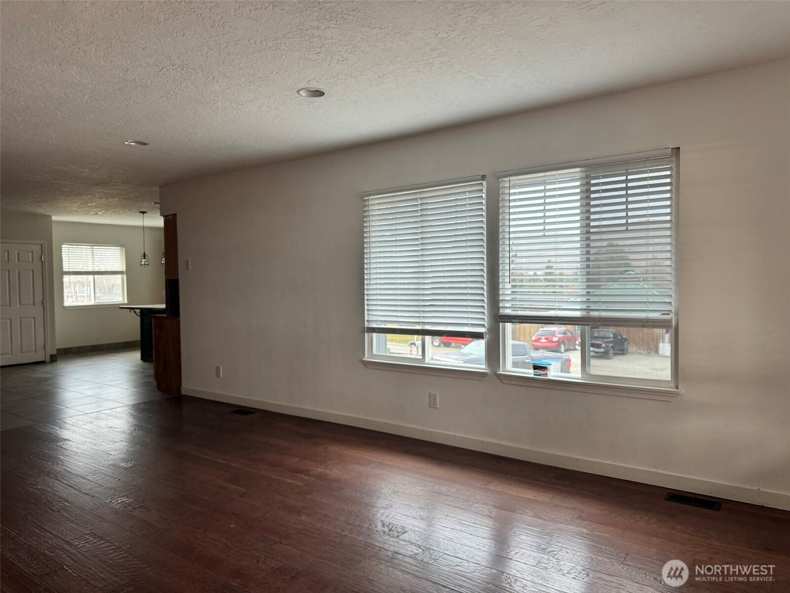 21 Orchard Loop North Tonasket, WA 98855 - Photo 10 of 23 an empty room with wooden floor and windows
