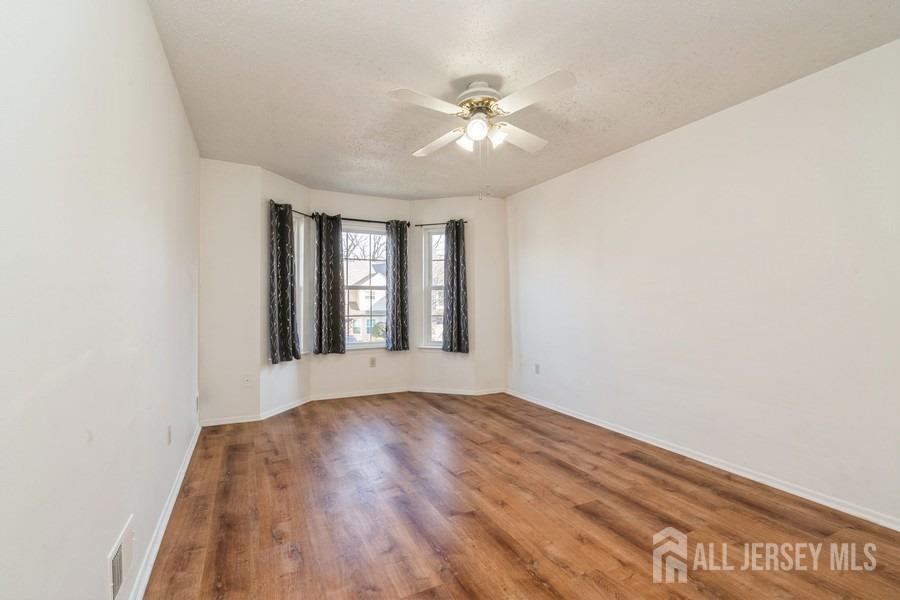 155 Nebula Road Piscataway, NJ 08854 - Photo 17 of 27 a view of an empty room with wooden floor and a window