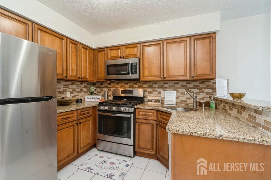 155 Nebula Road Piscataway, NJ 08854 - Photo 6 of 27 a kitchen with stainless steel appliances granite countertop a refrigerator stove microwave and sink