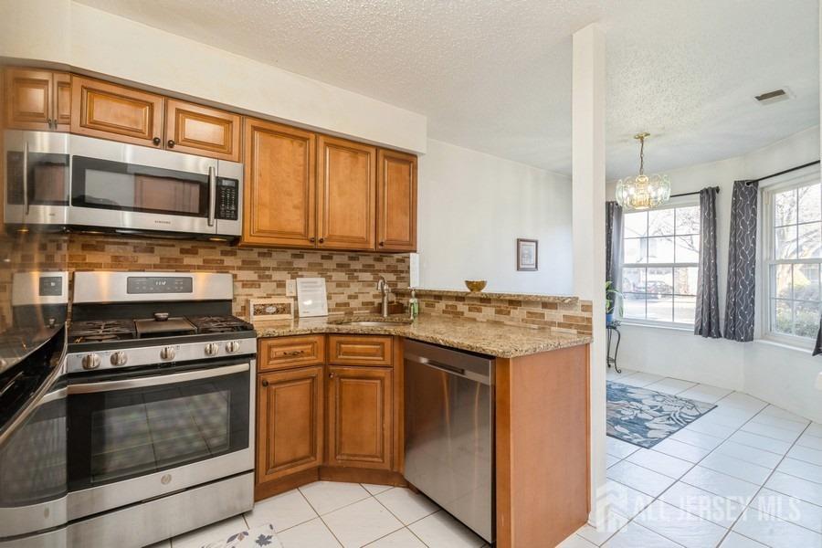 155 Nebula Road Piscataway, NJ 08854 - Photo 7 of 27 a kitchen with a stove top oven sink and cabinets