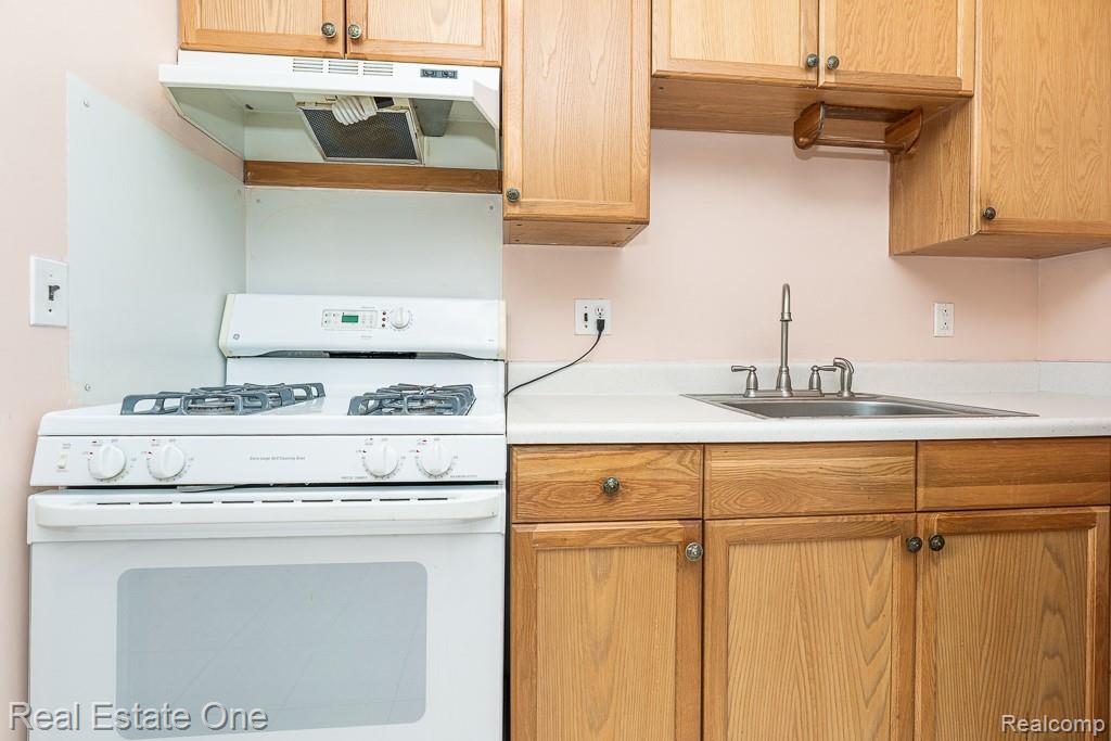 28777 West 11 Mile Road Farmington, MI 48336 - Photo 23 of 53 Kitchen featuring gas range gas stove, light countertops, and lots of cabinets