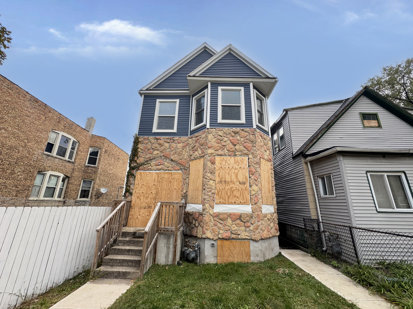 6227 South May Street Chicago, IL 60621 - Photo 1 of 13 a front view of a house with a yard
